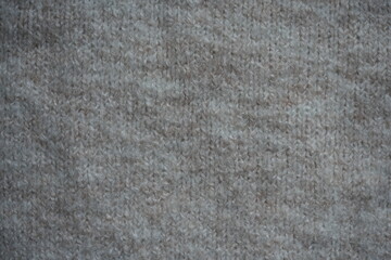 beige acrylic textile background beige knitted wool fabric texture close-up macro texture of beige knitted wool fabric as a background. soft yarn surface with smooth symmetrical knit pattern