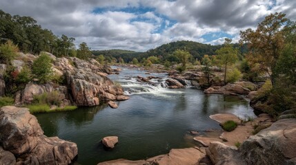 River flows through rocky landscape with trees under a cloudy sky.