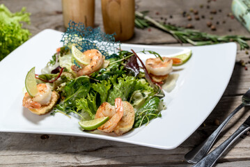 fresh salad with croquettes in a white plate