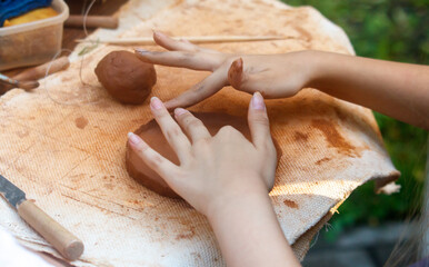 Person is making a clay pot