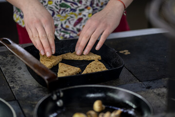 mushrooms and bread are fried in a pan on the stove