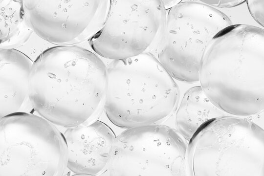 Transparent glass spheres with air bubbles close up, abstract background. Minimalistic composition symbolizing purity, clarity, freshness, science and modern design.