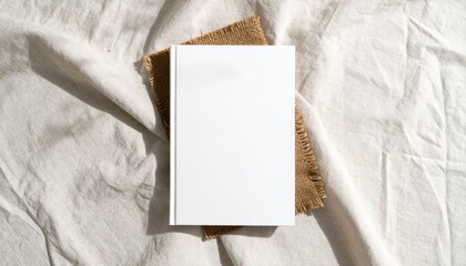 Blank White Book Cover Mockup on Textured Fabric