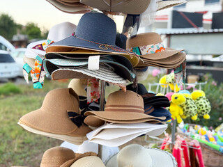 Bright summer hats on store rack. Fashion, tourism, and lifestyle accessories for sunny days.
