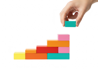 Hand stacking colorful blocks to form a staircase isolated on transparent background