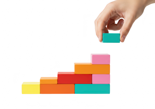 Hand stacking colorful blocks to form a staircase isolated on transparent background