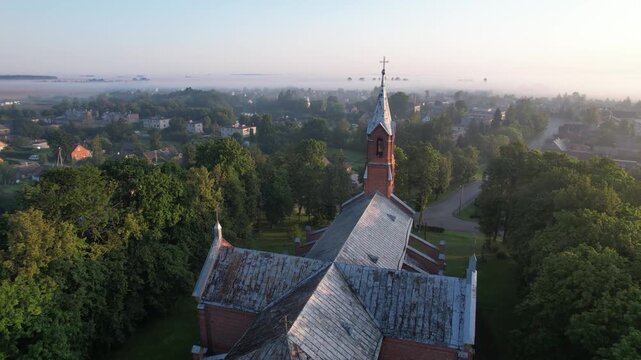 Church in the fog dawn in Krakes Lithuania