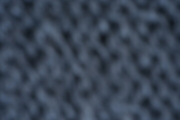 Fototapeta premium gray texture of knitted wool fabric as a background, grey smooth symmetrical lines of hand-knitted needlework pattern 