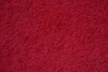 red dishwashing sponge texture close-up  macro texture of a red dishwashing sponge. detailed porous and fibrous structure used for kitchen cleaning. vibrant red color. perfect as a background or clean