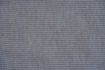 gray texture of knitted synthetic cotton fabric as a background, grey smooth symmetrical lines of synthetic fabric	
