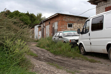 Old dirty car and white van