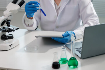 Fototapeta premium Scientist observing chemical reaction in glassware.
