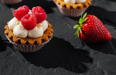 Delicious dessert with raspberries and strawberries on a textured surface