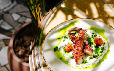 Fresh octopus dish with vibrant garnishes served in a stylish setting
