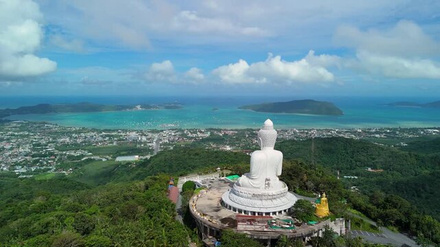 Aerial ascend push-back reveals The Big Buddha above Chalong Bay and Phuket hills