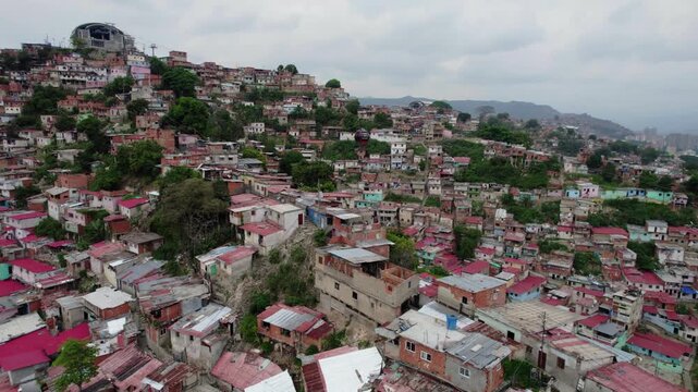 Aerial of MetroCable gondolas crossing hillside San Agust&iacute;n del Sur, Caracas