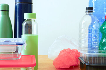 Contrast between disposable packaging like plastic bottles, containers and bags and reusable eco...