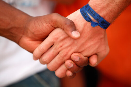 Youth holding hands.   Madrid. Spain.
