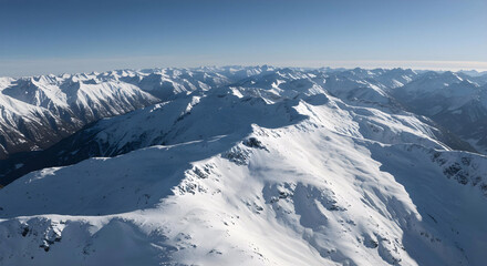 Aerial View of Snow-Covered Mountain Peaks in Winter at Sunrise