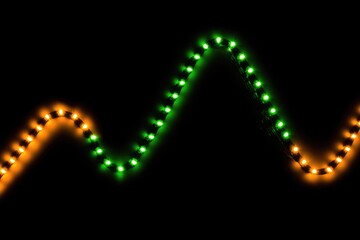 Orange and green LED lights form a wavy pattern against a black background