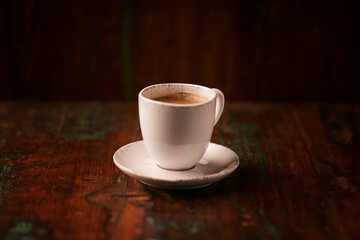 Cup of coffee on rustic wooden background. Soft focus. Copy space	