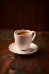Cup of coffee on rustic wooden background. Soft focus. Copy space	