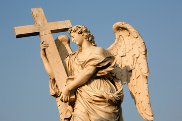 Saint Angelo bridge statue : Angel carrying cross.  Rome. Italy.