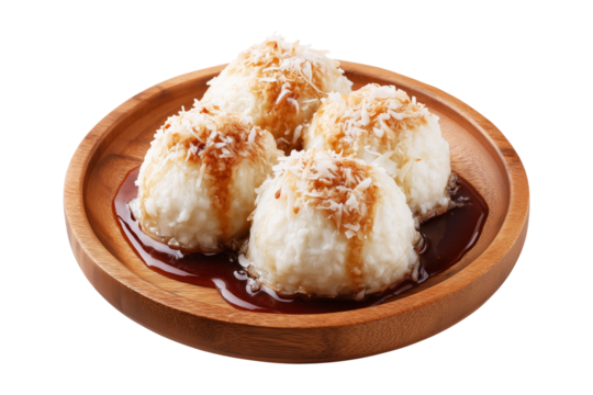 Coconut rice balls or dumplings topped with syrup and shredded coconut on wooden plate, isolated on white transparent background, concept of Polynesian Snacks Faikakai dessert cuisine
