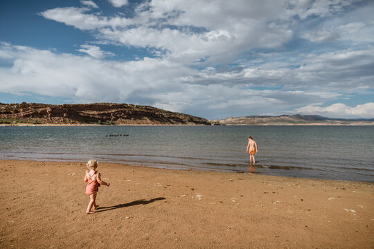 Young kids playing on shoreline of Green River in Utah