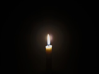 Candle light at night. Burning candle in darkness with focus. White candle burning in the dark,...
