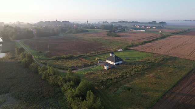 Church in the fog dawn in Krakes Lithuania