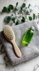 Spa scene brush, green liquid, towel, eucalyptus on marble