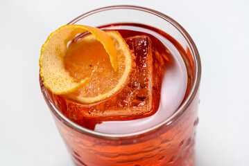 Campari cocktail in a glass on a light background macro photo