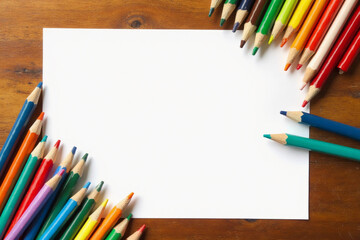 Blank paper and colorful pencils on the wooden table. View from above. 3d rendering.