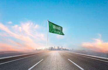 Saudi Arabia national flag with mast waving with beautiful skyline. A view from highway. Saudi Arabian flag for Republic Day and Independence Day.