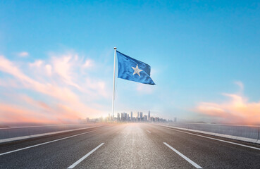 Somalia national flag with mast waving with beautiful skyline. A view from highway. Somalia flag...