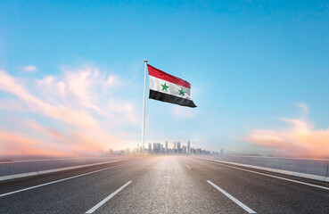 Syria national flag with mast waving with beautiful skyline. A view from highway. Syria flag for...