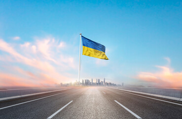 Ukraine national flag with mast waving with beautiful skyline. A view from highway. Ukraine flag...