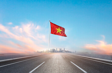 Vietnam national flag with mast waving with beautiful skyline. A view from highway. Vietnam flag...