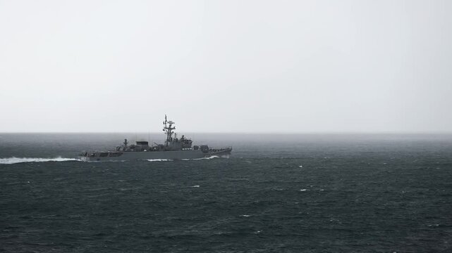 Armed navy patrol ship cruising deep blue sea