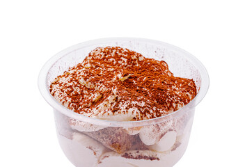 Tiramisu dessert in a clear container with cocoa powder topping