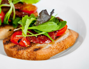 Gourmet toast with fresh tomatoes and greens