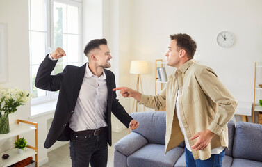 Two men are in a heated argument in a living room, with one man pointing and the other raising a...