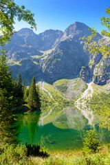 landscape with lake in mountains. scenic nature of poland with rocky peaks in summer. high tatras...