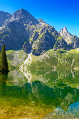 landscape with lake in mountains. scenic nature of poland with rocky peaks in summer. high tatras...