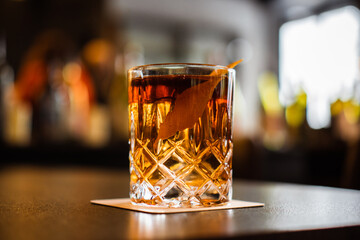 Negroni cocktail on the bar, bo. equal parts gin, vermouth rosso, and Campari, garnished with an...