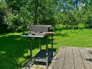 Naklejka premium barbecue area on the territory of a country house on a summer day. High quality photo