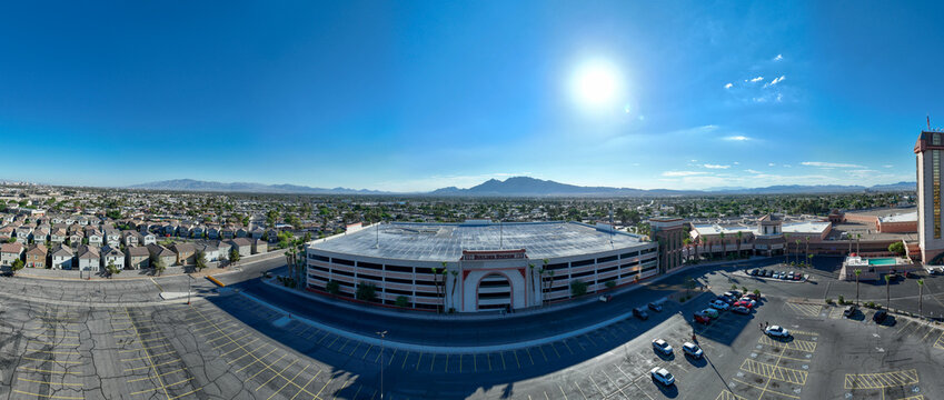 Aerial view of the bright sun shining over the Red Rock Casino Resort and Spa with mountains in the background, Las Vegas, Nevada, United States.