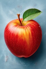 Bright red apple with leaf on painted chalk textured surface