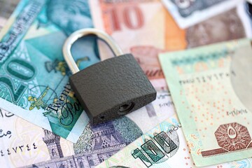 Egyptian pound currency money bills and padlock. The concept of sanctions and financial safety